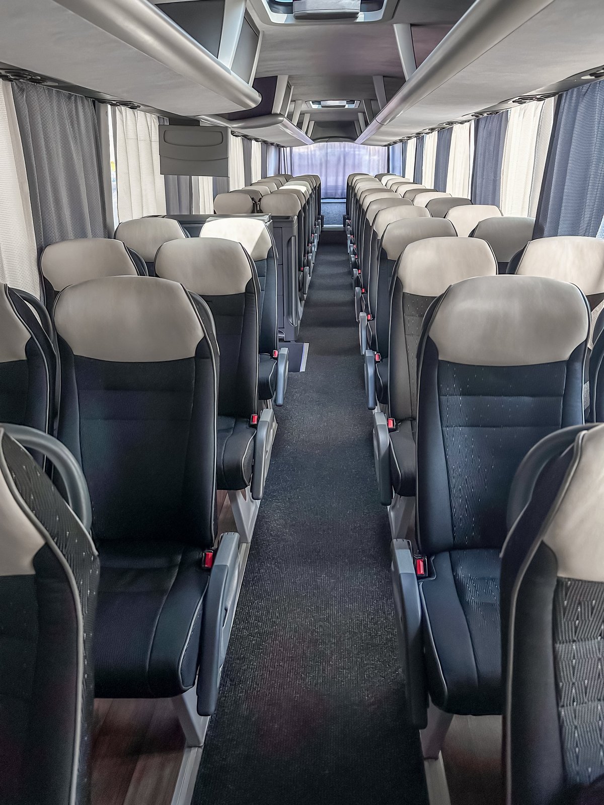 Interior of an Abyssinia coach, rows of seats seen from the aisle
